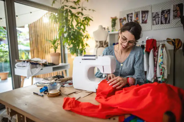 A lady tailoring a womens dress